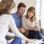 Couple reviewing paperwork with professional